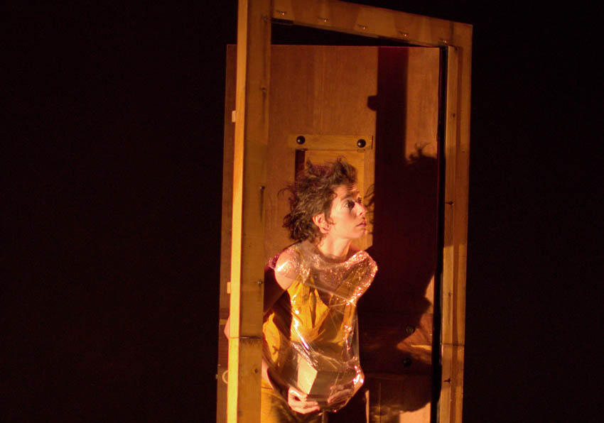 Un actor en l'escenari davant d'una porta oberta